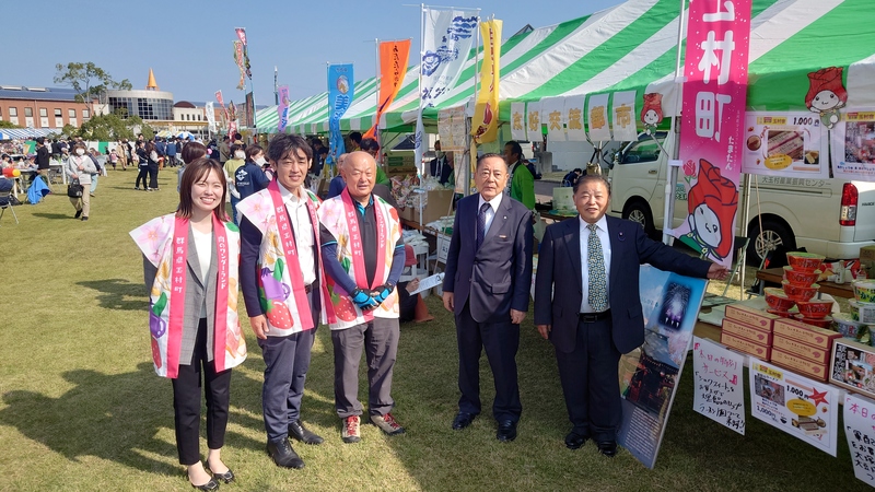 玉村町出店ブース担当者と記念撮影する石川町長