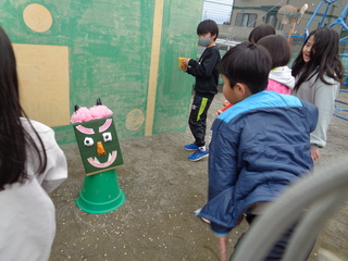 緑鬼に豆をまく子どもたち
